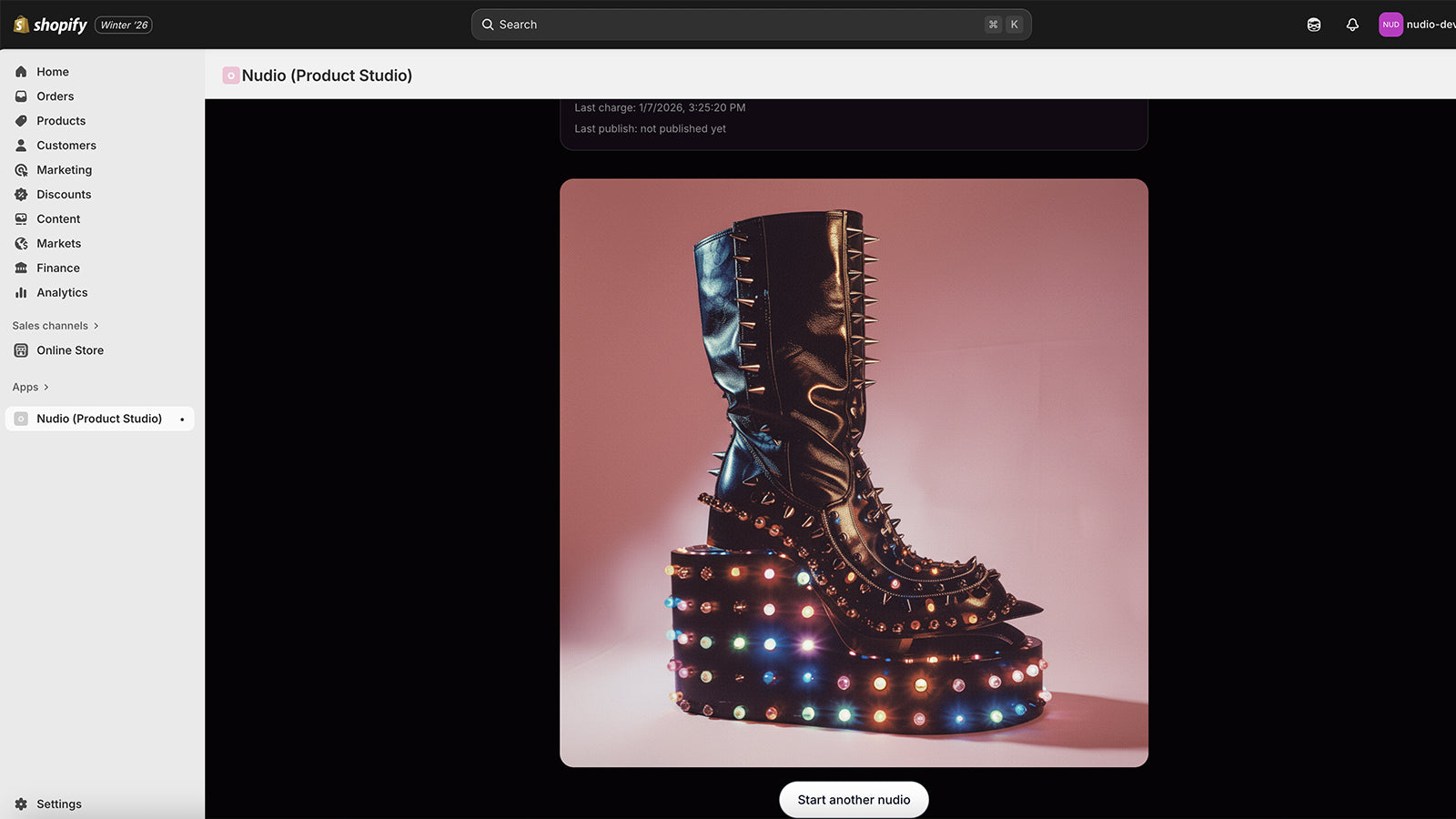 Nudio Application with staged boot over pink seamless. Well lit.